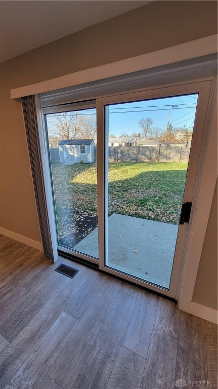 doorway with wood-type flooring