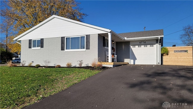 view of front of house featuring a garage and a front lawn