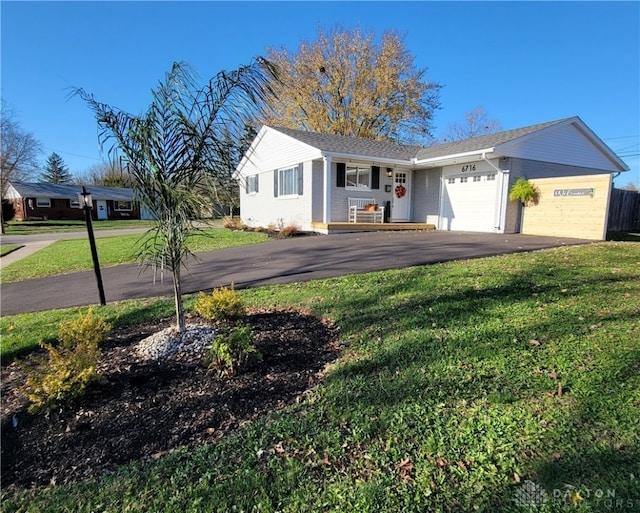 view of front of house featuring a front yard and a garage