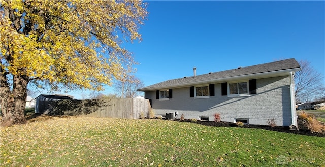 view of home's exterior with a yard and central AC unit