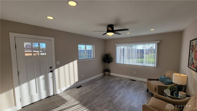 entrance foyer with dark hardwood / wood-style flooring, ceiling fan, and a healthy amount of sunlight