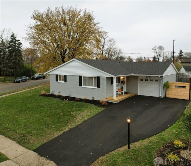 single story home with a garage and a front yard