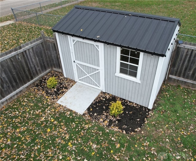 view of outdoor structure featuring a lawn