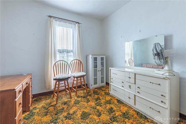 sitting room featuring dark colored carpet