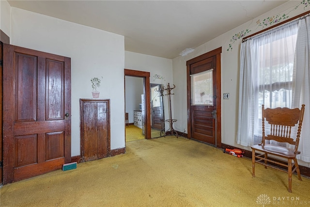 entrance foyer featuring light colored carpet