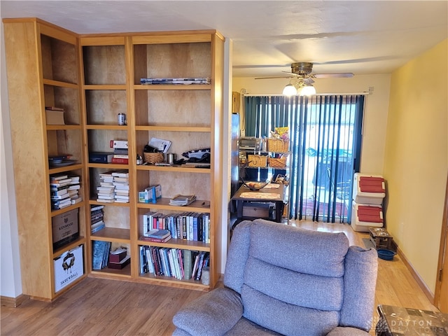 sitting room with hardwood / wood-style flooring and ceiling fan