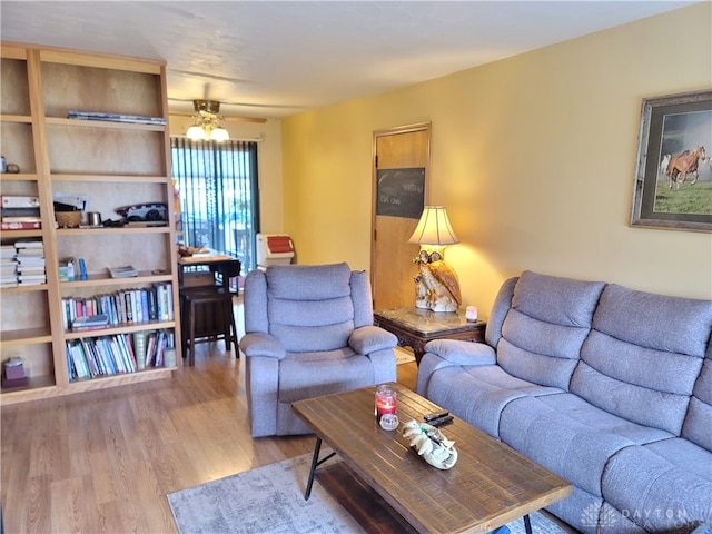 living room with hardwood / wood-style flooring and ceiling fan