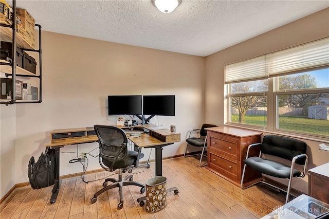 office space featuring light hardwood / wood-style floors and a textured ceiling