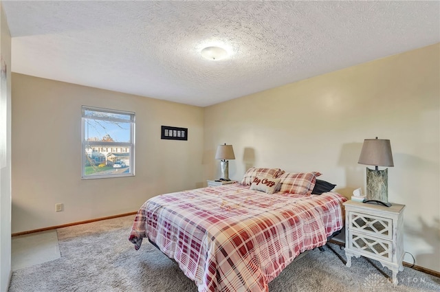 carpeted bedroom with a textured ceiling