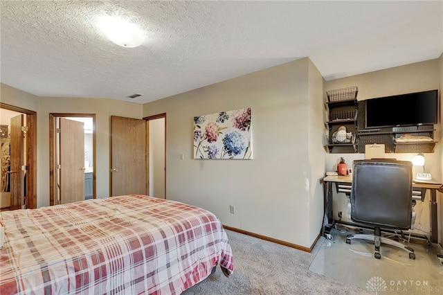 bedroom featuring light carpet and a textured ceiling