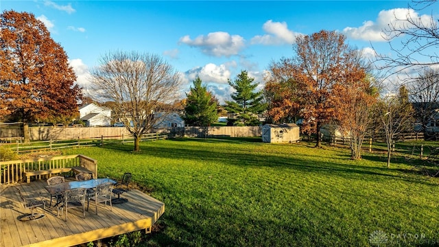 view of yard featuring a shed and a wooden deck