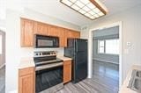 kitchen featuring black appliances and light hardwood / wood-style floors