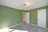 unfurnished bedroom with dark wood-type flooring