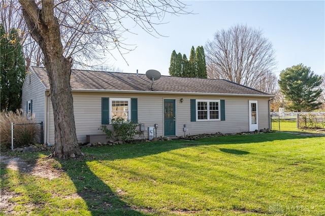 ranch-style home featuring a front yard