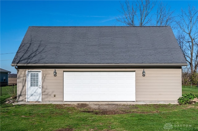 garage featuring a lawn