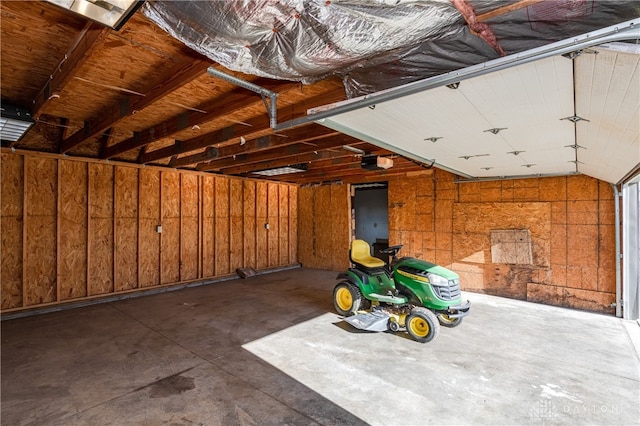 garage with wooden walls and a garage door opener