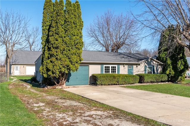 ranch-style house featuring a garage and a front yard