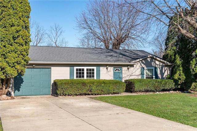 ranch-style home with a garage and a front lawn