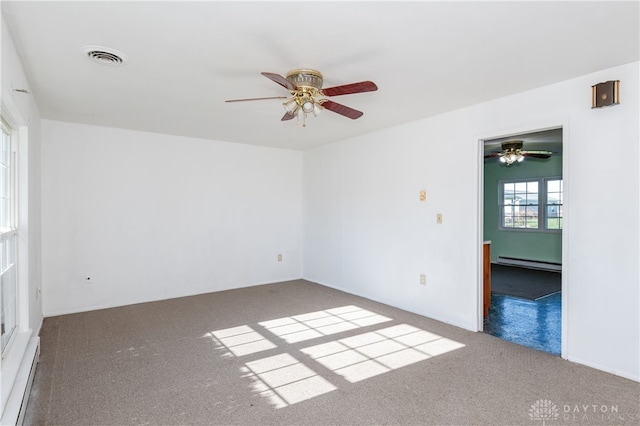 spare room featuring carpet flooring, ceiling fan, and baseboard heating