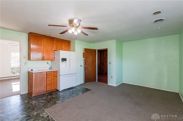 kitchen featuring ceiling fan, white fridge with ice dispenser, and a baseboard radiator