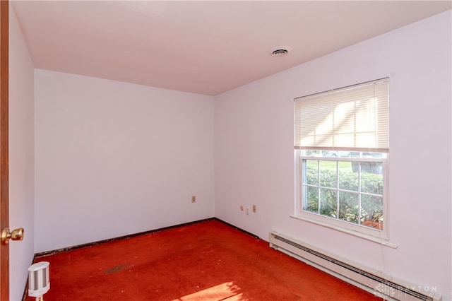 carpeted empty room featuring baseboard heating