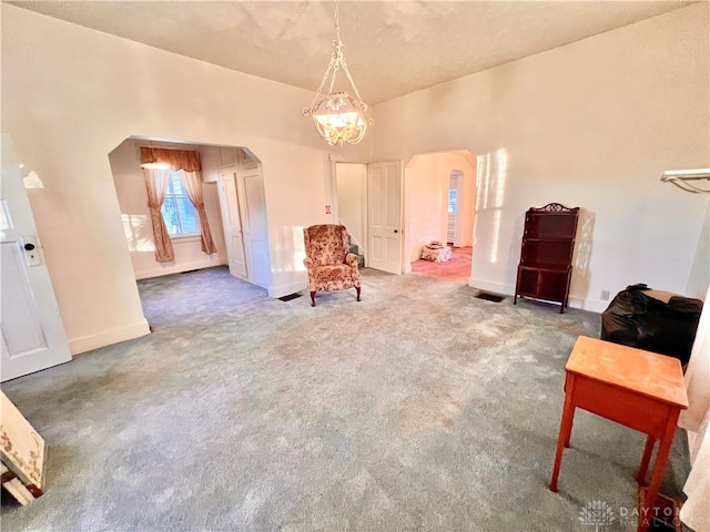 living area with carpet floors and a chandelier