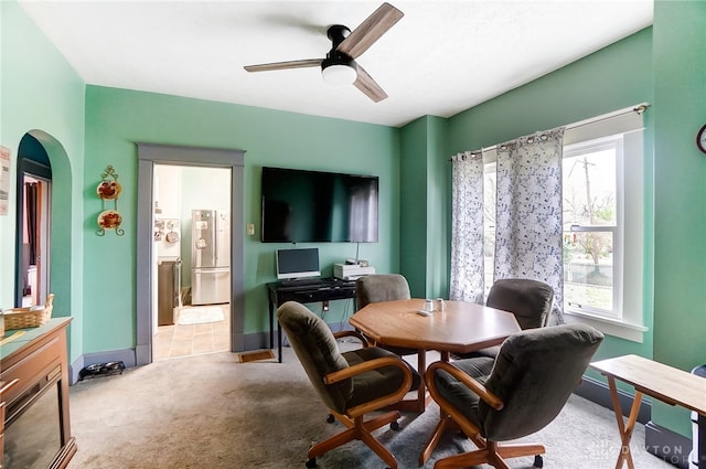 dining area with light carpet and ceiling fan