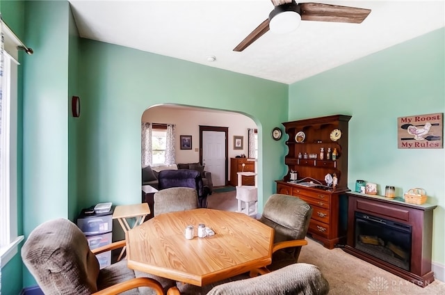 carpeted dining area featuring ceiling fan