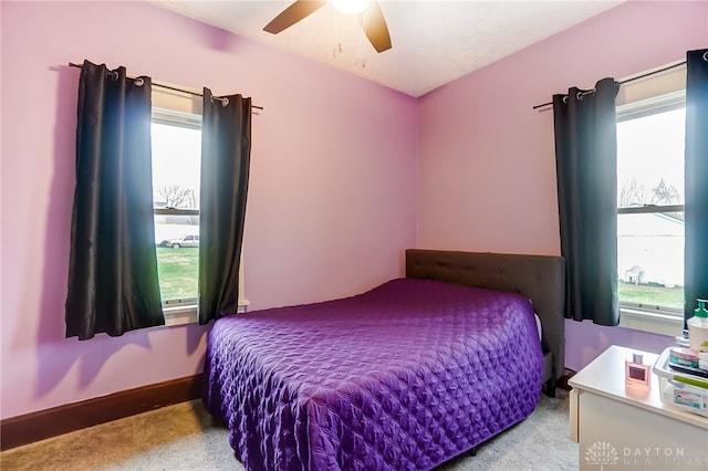 bedroom featuring ceiling fan and light carpet