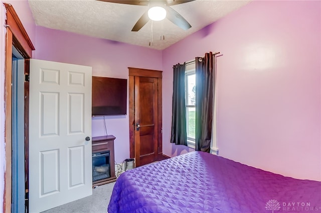 bedroom featuring a textured ceiling and ceiling fan