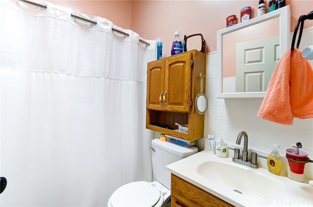 bathroom with decorative backsplash, toilet, and vanity