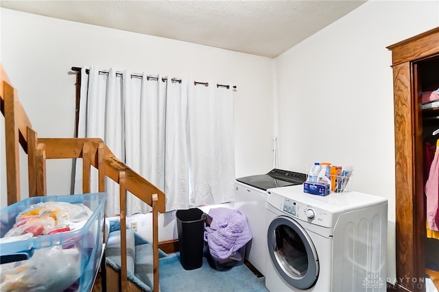 laundry area with washer and clothes dryer, a textured ceiling, and carpet