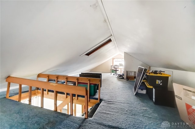 bonus room with vaulted ceiling and dark colored carpet