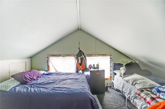 carpeted bedroom featuring lofted ceiling