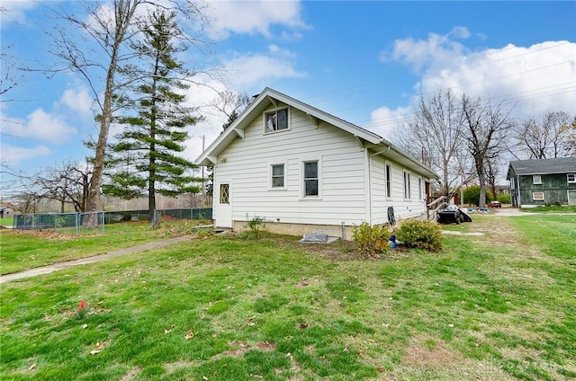 view of side of home with a yard