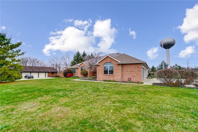 ranch-style house featuring a front lawn and a garage