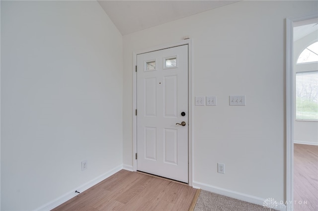 foyer with lofted ceiling and light hardwood / wood-style flooring