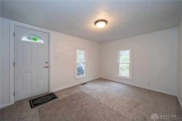 foyer with light colored carpet