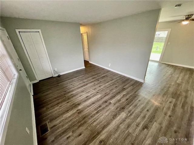 unfurnished room with dark hardwood / wood-style flooring and ceiling fan