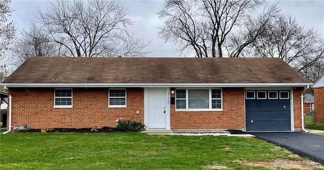 view of front of property with a garage and a front lawn