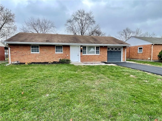 single story home featuring a front lawn and a garage