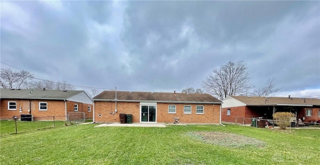 back of property featuring cooling unit, a patio area, and a lawn