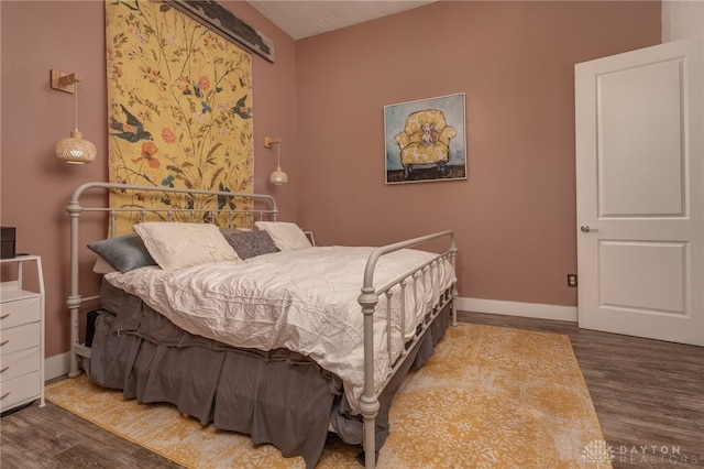 bedroom with hardwood / wood-style flooring