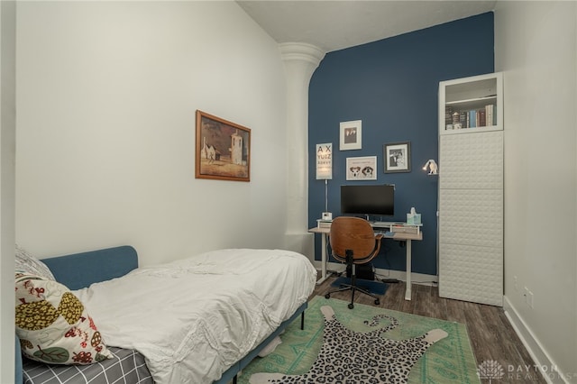 bedroom with dark hardwood / wood-style flooring and lofted ceiling