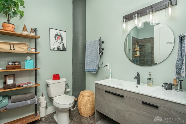 bathroom featuring tile patterned floors, vanity, toilet, and walk in shower