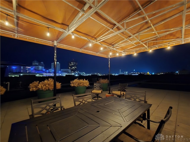 deck at night featuring a water view