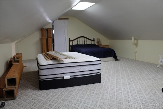 carpeted bedroom with vaulted ceiling