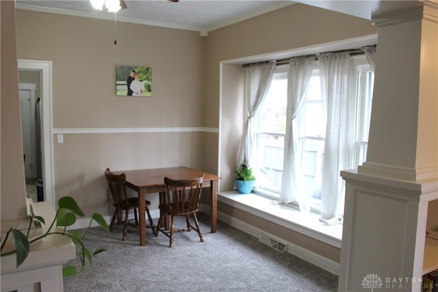 dining area with carpet, a healthy amount of sunlight, and crown molding