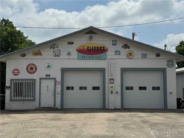 view of front of property with an outdoor structure and a garage