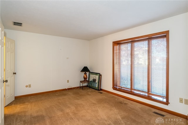 unfurnished living room featuring light colored carpet